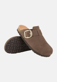 Brown suede clogs with a buckle detail, featuring a textured black rubber sole and a soft tan interior.