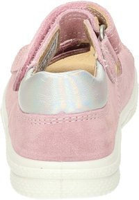 Pink suede shoe with a shiny silver heel accent and white sole; features a hook-and-loop strap for easy adjustment.