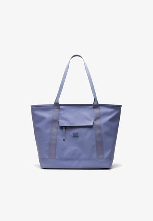 Sac cabas lavande avec longues anses, une poche à rabat sur le devant et le logo "Herschel Supply Company" embossé sous la poche.