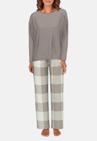 Light gray long-sleeve top paired with loose-fitting cream and taupe checkered pajama pants. Soft fabric with a relaxed fit.