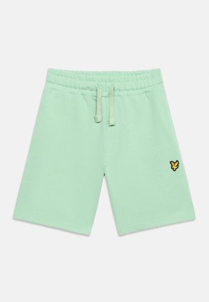 Mündirohelised elastse vöökohaga lühikesed püksid nööriga ning vasakul jalal väike kollase ja musta värvi tikitud linnu logo.