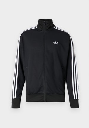 Μαύρο αθλητικό μπουφάν με φερμουάρ, κατασκευασμένο από διαπνέον ύφασμα δίχτυ, με λευκές ρίγες στα μανίκια και μικρό λευκό λογότυπο στο στήθος.