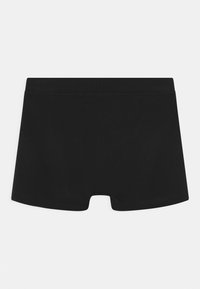 Svarta bomullstrosor i boyshorts-stil med en slät textur, med en sömlös midja och en öppen bendesign. Enkla och i en enhetlig färg.