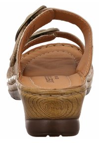 Bruine leren sandalen met verstelbare banden, een gevormde voetbed en een textuur hiel. Voorzien van metalen accenten en zichtbare stiksels.