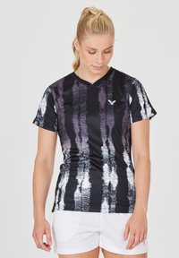 Sort og hvid kortærmet sportstop med V-udskæring, prydet med et tekstureret mønster af lodrette striber og et lille logo på brystet.