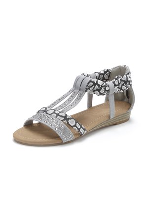 Grey flat sandal with rhinestones, animal print straps, and padded ankle support on tan sole and low wedge heel.