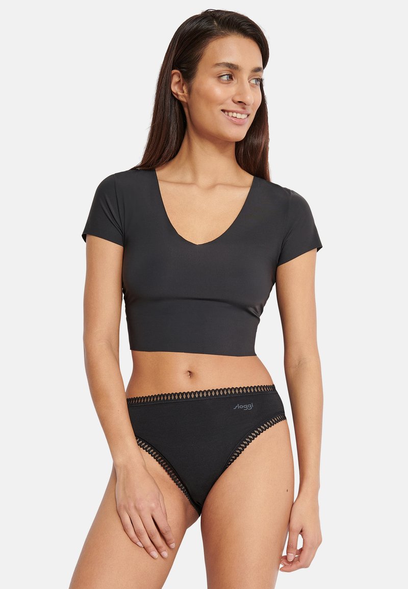 Top corto nero a maniche corte con scollo a V profondo e mutandine a vita alta abbinate con rifiniture in pizzo lungo i bordi. Tessuto morbido al tatto.