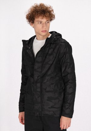 Black camouflage jacket with a hood, zip closure, and two front pockets; made of smooth, lightweight material; long sleeves and a relaxed fit.