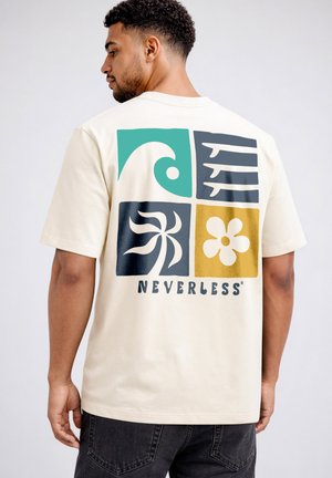 Man facing sideways wearing cream T-shirt with four colorful graphic squares and "NEVERLESS" text on the back.