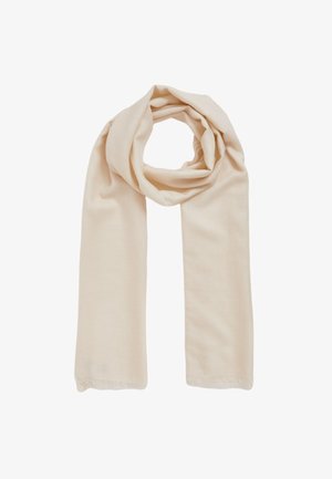 Pehmeä beige villahuivi taitettuna löysään lenkkiin, molemmat päät roikkuvat symmetrisesti valkoisella taustalla.