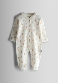 Valge beebikombekas, millel korduv jänese ja lillemotiiv. Disainitud pikkade varrukate, kinnitusnuppude ja jalakatteta alaosaga. Pehme kangas.