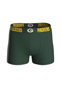 Boxers de algodón verdes con una cinturilla amarilla que presenta el texto "PACKERS" y un logotipo circular. El diseño es ajustado y tiene una textura suave.