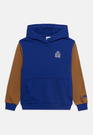 Niebieska bluza z kapturem z brązowymi rękawami, przednią kieszenią, białym herbem Nike na piersi i niebieskim logo Nike na mankiecie lewego rękawa.
