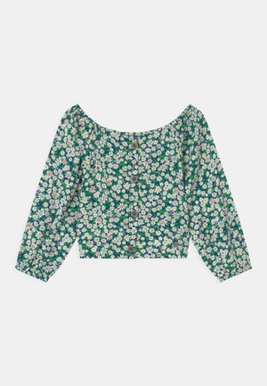 Grüne, kurz geschnittene Bluse mit langen Ärmeln, weißem Gänseblümchen-Blumenmuster und Knopfleiste vorne.