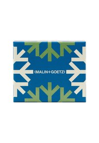Rechteckige blaue Box mit weißen und grünen geometrischen Schneeflockenmuster; zeigt den Schriftzug "MALIN+GOETZ" in Weiß.