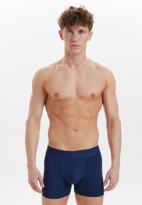 Marineblå boxershorts i mjuk bomull, med en slät midja som har präglad logodetalj. Fitted design för komfort.