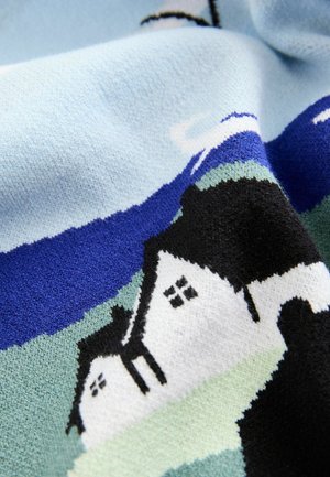 Megztas audinys, vaizduojantis kraštovaizdžio motyvą su namais, mėlynu dangumi ir žaliais žemės plotais švelnių pastelinių spalvų.