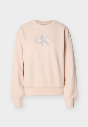 Hele roosa Calvin Kleini pusa, millel on pikad varrukad, ümar kaelus, soonikkoes mansetid ja esiküljel helehallide ja valgete tähtedega logo.