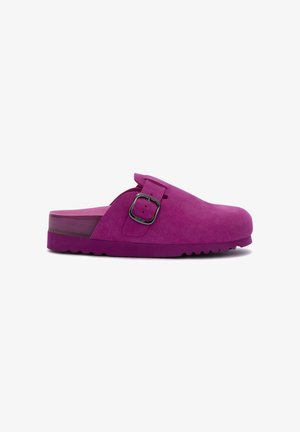 Purple suede clogs feature a strap with a silver buckle, a thick purple sole, and a textured, slip-resistant bottom surface.