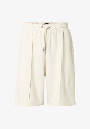 Krém színű, térdig érő rövidnadrág rugalmas derékrésszel és húzózsinórral, oldalzsebekkel és finom logóval a lábán.