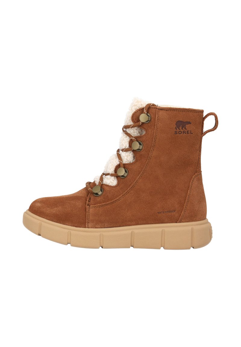 Brown suede ankle boot with a plush white lining, lace-up front, metal eyelets, and a beige rubber sole. "SOREL" logo on side. Waterproof.