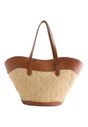 Handtaske med brune læderhåndtag og kant, beige tekstureret stof med et hævet bladmønster.