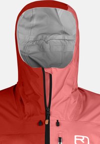 Red and pink waterproof jacket with a high collar, adjustable hood, and black zippers. Features a logo on the chest and smooth texture.