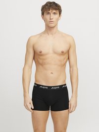 Schwarze Boxershorts mit einem kontrastierenden weißen Bund, auf dem der Markenname "aprel" steht. Aus glattem, elastischem Material gefertigt.