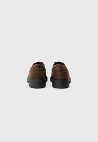 Brown suede shoes with a sleek design, rubber sole, rounded toe, and minimal stitching details. View shows the rear of the footwear.