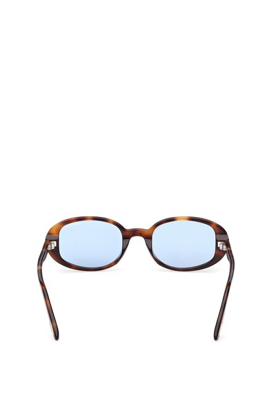 Sluneční brýle s obroučkou z želvoviny, oválným tvarem a světle modrými čočkami. Na stranách jsou kovové ozdoby.