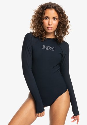 Langærmet svømmetøj i marineblå med en tætsiddende pasform. Har et hvidt "ROXY" logo og glat, strækbart stof. Minimalistisk stil uden yderligere mønstre.