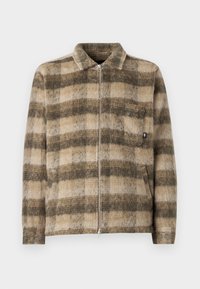 Checkered, zip-up jacket in tan and dark brown, featuring a soft textured fabric, collar, and a front pocket with a small logo detail.