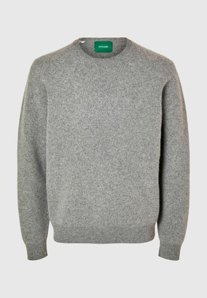 Pilkas vilnos megztinis su apvalia apykakle, ilgomis rankovėmis ir siaurėjančiomis rankogaliais bei apačia. Ant megztinio yra etikėtė su prekinio ženklo "ANNARR" pavadinimu.