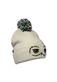 White knitted beanie with black and gray pom-pom, featuring embroidered eyes and mustache detail in black and orange on the front.