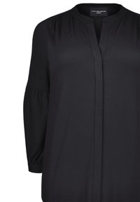 Czarna bluzka z kołnierzykiem stójkowym, miękka w dotyku, z długimi rękawami zakończonymi elastycznymi mankietami oraz bezguzkowym zapięciem z przodu. Prosty, uniwersalny design.