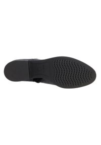 Suola di scarpa nera in gomma testurizzata per la presa, caratterizzata da motivi circolari e a onda, con il logo Geox impresso sul lato.