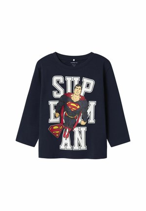 Navy long-sleeve t-shirt featuring a large Superman graphic, with white text reading "SUPERMAN" and red accents on the logo and cape.