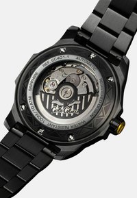 Automatische Uhr mit einem Gehäuse und Armband aus schwarzem Edelstahl. Verfügt über einen strukturierten Rückendeckel, Saphirglas und filigrane mechanische Details.