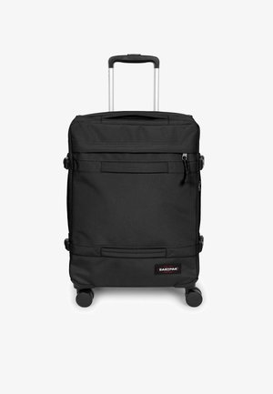 Valigia nera di forma rettangolare, realizzata in tessuto resistente. Presenta due tasche frontali, un manico retrattile e quattro ruote per la mobilità.