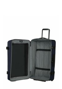 Valise marine avec un intérieur gris, dotée d'une poche en filet zippée, de sangles ajustables et d'une poignée rétractable. Design extensible.