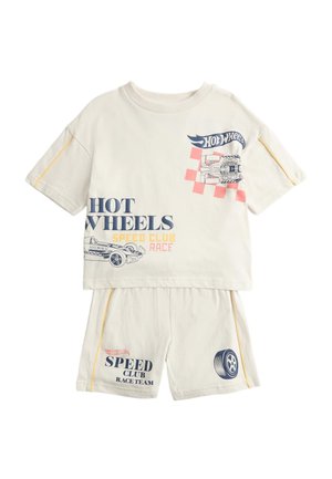 Children's beige two-piece outfit with Hot Wheels car and tire graphics, and text "Hot Wheels Speed Club Race" on top and shorts.
