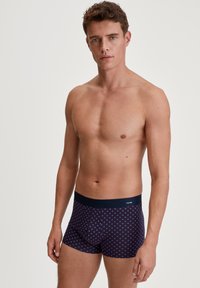 Men's boxer shorts in navy with a geometric pattern in light blue. Made from soft fabric, featuring a comfortable elastic waistband.