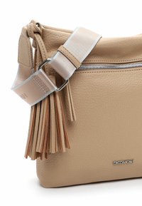 Beige leather crossbody bag with a textured finish, silver hardware, zip closure, and decorative leather tassels on the strap.