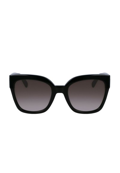 Lunettes de soleil noires avec une monture audacieuse et angulaire en forme d'œil de chat, des verres gris dégradés et un matériau en plastique brillant.