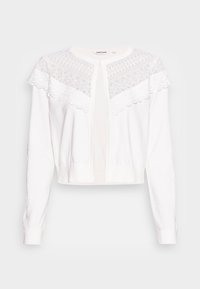 Bílý krátký kardigan s krajkovým sedlem s geometrickými vzory, dlouhými rukávy a zapínáním vpředu. Měkká pletená látka.