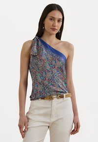 One-shoulder top featuring colorful paisley print on a blue background, with a satin-like texture and a decorative bow detail at the shoulder.