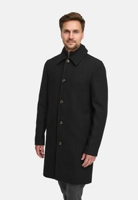 Svart ullfrakk med bred krage, seks frontknapper, sidelommer, og rett snitt, designet for en skreddersydd passform.