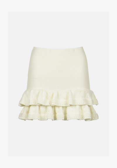 Pinti kreminės spalvos sijonas su prigludusia palaidine ir raukšlėta, tekstūruota apatine dalimi. Prabangus, minkštas audinys su sluoksniuota struktūra.