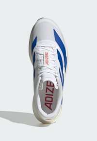 White athletic shoe with blue accents, mesh upper, and a textured sole. Features red "ADIZERO" logo on the tongue. Lightweight design.