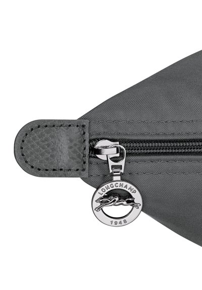 Black fabric bag zipper pull with silver Longchamp logo charm featuring a horse and "LONGCHAMP 1948" text.